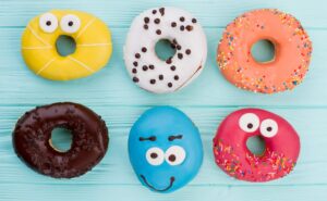 Group of different donuts on color background.